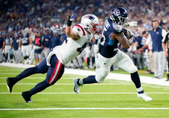 Tennessee Titans running back Julius Chestnut (36) scores a touchdown past New England Patriots linebacker Diego Fagot (42) during the second quarter at Nissan Stadium.